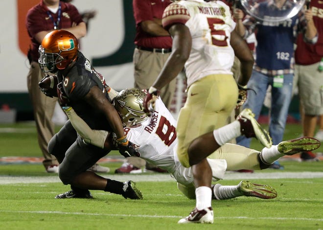 Miami running back Duke Johnson tries to get away from Florida State defensive back Jalen Ramsey during a Nov. 15 game.