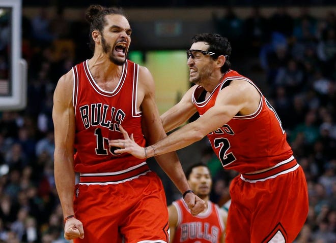Chicago center Joakim Noah, left, celebrates with guard Kirk Hinrich after making a crucial basket in the last minute of the Bulls' 109-102 win over the Celtics on Friday afternoon at the Garden.