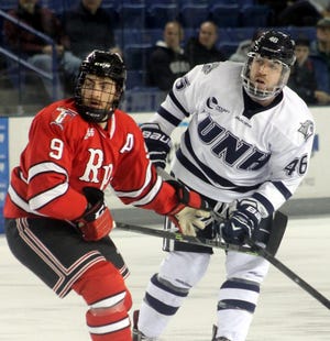 UNH’s Ryan Randall, right, follows the puck along with RPI’s Matt Neal during Tuesday night’s game at the Whittemore Center.