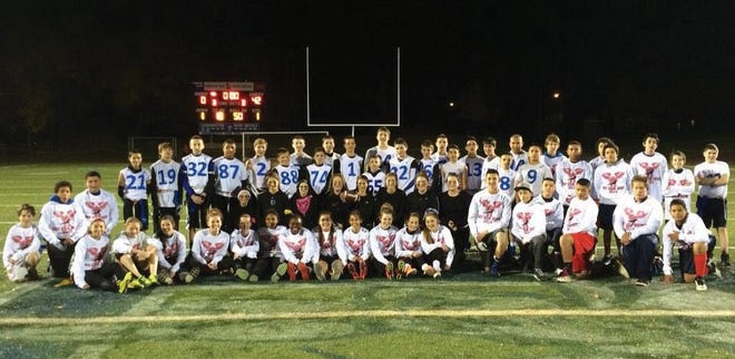 Top, Teams in the SkySam Bowl gather for a photograph. The girls’ team from Sky View Middle School won 42-0.