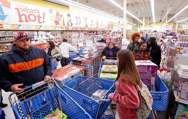 Shoppers weave through aisles of items looking for deals at Toys R Us in Tuscaloosa, Ala. Thursday, Nov. 27, 2014. The store opened at 5 PM Thanksgiving day and will remain open for business until 11 PM Friday. A line of shoppers wound around the building waiting to get deals Thursday afternoon. Michelle Lepianka Carter | The Tuscaloosa News
