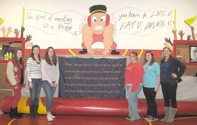 Members of the Reading Art Club stand beside a recently completed mural in the school's wrestling room. Pictured include Taylor Stewart, Ann Weidmayer, Aleksandra Pukula, Charlene Zimmerman, Amanda Wentz-Gardner, Juliet Fabey and advisor Jennifer Flynn. COURTESY PHOTO