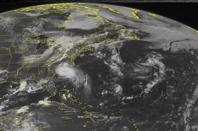 This NOAA satellite image taken Thursday, July 03, 2014 at 10:45 AM EDT shows Hurricane Arthur off the coast of the Carolinas moving northeast with maximum sustained winds of 90mph. A cold front tracks eastward into the Northeast and Mid-Atlantic with showers and thunderstorms.