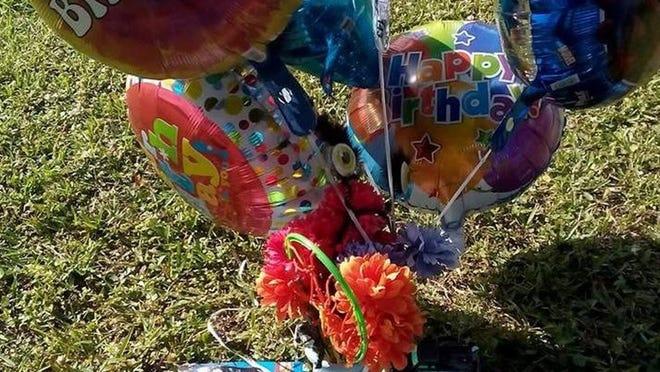 Balloons, toys and a cupcake sit on top of I’zarion Colin’s grave at Glenwood Cemetery. The 18-month-old was shot May 29 and died the next day. I’zarion would have turned 2 Saturday. Photo provided by family