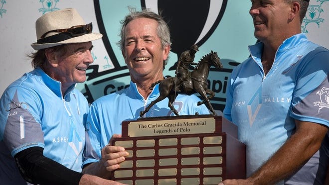 From left to right, Glenn Straub, Carlos Gracida’s cousin Ruben Gracida and Tommy Biddle, all of the Aspen Valley Polo Club, pose with the trophy after defeating the Grand Champions team, 5-4, during the inaugural “Carlos Gracida Memorial Legends of Polo” match at Grand Champions Polo Club in Wellington on Saturday. Carlos Gracida passed away in February after a polo accident. (Madeline Gray / The Palm Beach Post)