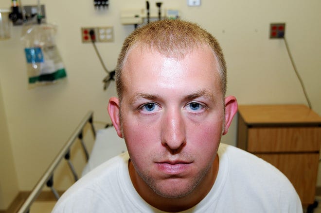 FILE- This undated file photo released by the St. Louis County Prosecuting Attorney's office on Monday, Nov. 24, 2014, shows Ferguson police officer Darren Wilson during his medical examination after he fatally shot Michael Brown,†in Ferguson, Mo.†The white police officer who killed Michael Brown has resigned from the Ferguson Police Department, nearly four months after the confrontation that fueled protests in the St. Louis suburb and across the U.S. Wilson has been on administrative leave since the Aug. 9 shooting. His resignation was announced Saturday, Nov. 29, 2014, by one of his attorneys, Neil Bruntrager. Bruntrager said the resignation is effective immediately. (AP Photo/St. Louis County Prosecuting Attorney's Office, File)