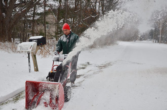 Mike Ramirez plows the snow away from his mailbox to make it easier for his mailman to maneuver Friday, Nov. 28. Andrew Whitaker/Sentinel Staff