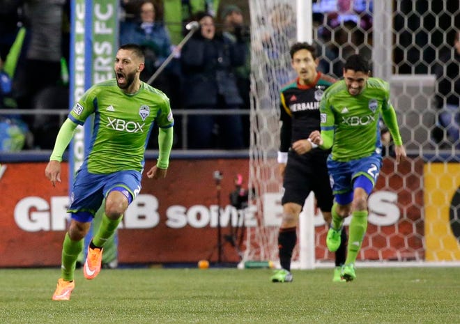 Seattle Sounders forward Clint Dempsey, left, celebrates with teammates after he scored a goal against the Los Angeles Galaxy in the first half of the second leg of the MLS western conference final soccer match, Sunday, Nov. 30, 2014, in Seattle.