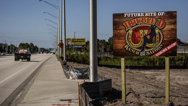 Signage and cleared land at the future site of the Double D Ranch and Saloon, a strip club, at 8162 Southern Blvd. west of West Palm Beach. (Thomas Cordy / The Palm Beach Post)