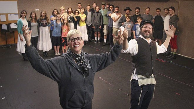 From left: Director and choreographer Marcia Milgrom Dodge and actor Robert Petkoff, dressed as the character Tevye, stand before the cast of Fiddler on the Roof inside Maltz Jupiter Theatre Monday, November 25, 2014. (Damon Higgins/The Palm Beach Post)