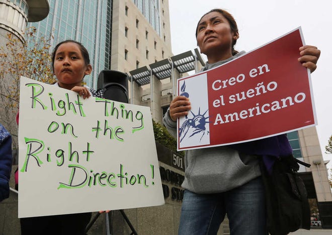 Edith Cuautle, right, who has been living in the country illegally, and her daughter, Karen, 8, who was born in the United States, joined dozens of others who are here illegally, as well as activists and supporters to celebrate President Barack Obama's executive action on illegal immigration, at a at a news conference in Sacramento, Calif., Friday, Nov. 21, 2014. Under the presidents plan Cuautle is eligible for protected status because her daughter was born in the U.S.(AP Photo/Rich Pedroncelli)
