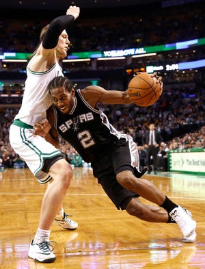San Antonio Spurs' Kawhi Leonard drives against Boston Celtics' Kelly Olynyk on Sunday during the Spurs' 111-89 win in Boston.Winslow Townson/AP