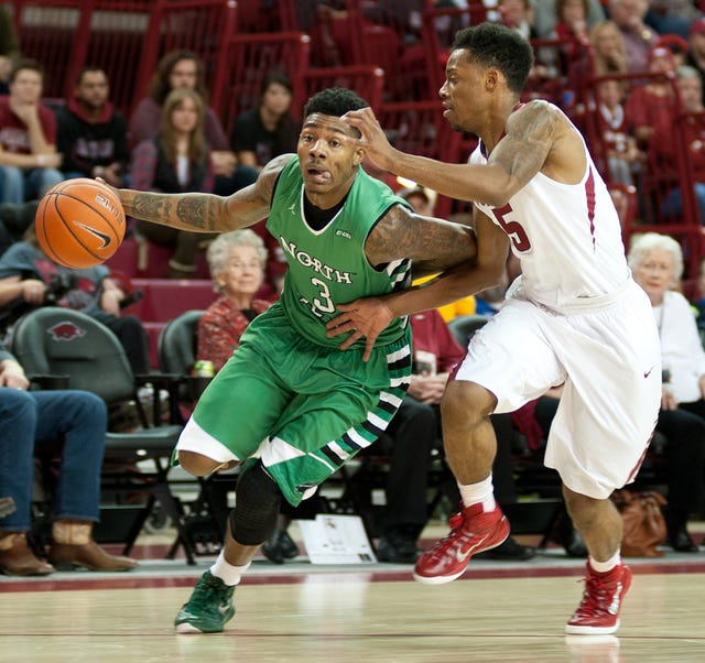 North Texas' DeAndre Harris (3) drives the ball to the hoop as Arkansas' Anthlon Bell (5) defends in the first half of an NCAA college basketball game in Fayetteville, Ark., Friday, Nov. 28, 2014. (AP Photo/Sarah Bentham) 
 Arkansas' Anthlon Bell (5) drives the ball by North Texas' T.J. Taylor (21) in the second half of an NCAA college basketball game in Fayetteville, Ark., Friday, Nov. 28, 2014. Arkansas won 89-73. (AP Photo/Sarah Bentham)