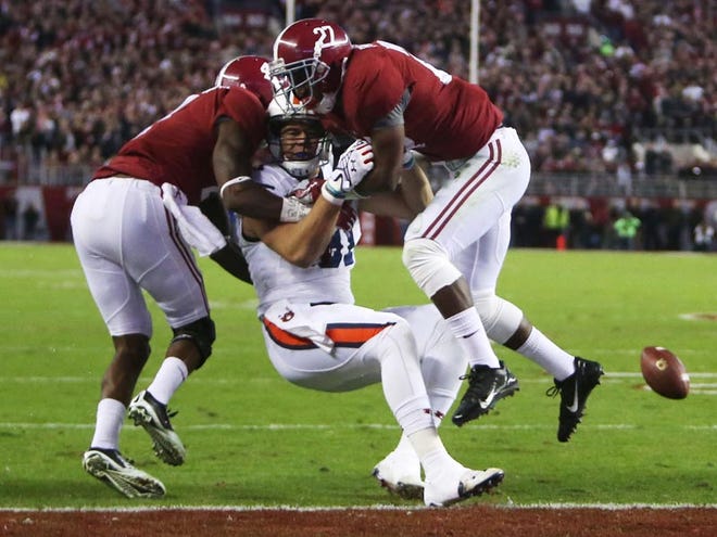 Alabama defensive back Eddie Jackson (4) and Alabama defensive back Nick Perry (27) tackle Auburn tight end C.J. Uzomah (81) on Saturday. Alabama gave up 630 yards of offense against Auburn, the most in Iron Bowl history.