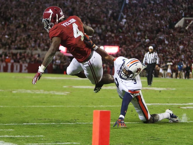 Alabama running back T.J. Yeldon (4) is knocked out of bounds by Auburn defensive back Jonathan Jones during the second half of the Iron Bowl at Bryant-Denny Stadium on Saturday. Yeldon rushed for 127 yards and two touchdowns in the Crimson Tide's 55-44 win. This weekend, No. 1 Alabama faces off against No. 14 Missouri in the SEC Championship Game.