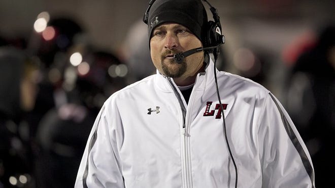 Lake Travis head coach Hank Carter paces the sidelines during early action. Lake Travis plays host to Rouse in a first round playoff game at Lake Travis Stadium Thursday night November 13, 2014.