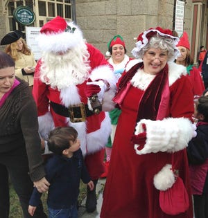 Santa and Mrs. Claus arrive at the Fall River Historical Society on Sunday.