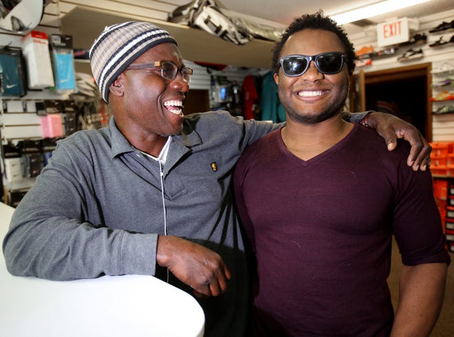 Blessing Offor, right, poses for a photo with his uncle, Chigozie Offor, left, at TopSeed Tennis and Soccer on Southwest Third Avenue in Ocala on Friday, Nov. 28, 2014.