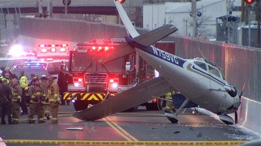 This photo provided by NBC Connecticut News shows the single engine plane that landed on a bus-only roadway in West Hartford, Conn., Saturday, Nov. 29, 2014.