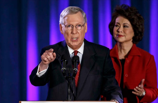 FILE - In this Nov. 4, 2014 file phot, Senate Minority Leader Mitch McConnell of Ky., joined by his wife, former Labor Secretary Elaine Chao, celebrates with his supporters at an election night party in Louisville, Ky. President Barack Obama has the upper hand in the fierce struggle over immigration now taking shape, with a veto pen ready to kill any Republican move to reverse his executive order, Democrats united behind him and GOP congressional leaders desperate to squelch talk of a government shutdown or even impeachment. With the public favoring changes in the current immigration system, the Republicans' best short-term response appears to be purely rhetorical: that the president is granting amnesty to millions, and exceeding his constitutional authority in the process. McConnell and House Speaker John Boehner aren't interested in provoking a government shutdown as a way to block spending needed to carry out Obama's order, viewing that as a poor way to embark on a new era of Republican control of Congress. (AP Photo/J. Scott Applewhite, File)