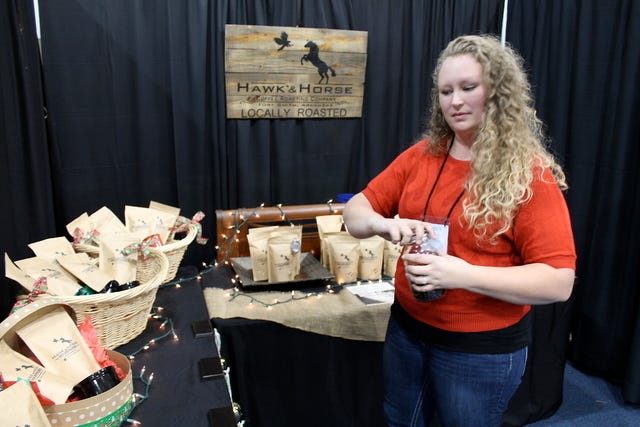 John Lovett • Times Record /
Kaity Gould of Hawk & Horse Coffee Roasting Company is seen at the Junior League's 21st annual Holiday Market at the Fort Smith Convention Center, Friday, Nov. 20, 2014. 
 John Lovett • Times Record /
Kaity Gould of Hawk & Horse Coffee Roasting Company is seen at the Junior League's 21st annual Holiday Market at the Fort Smith Convention Center, Friday, Nov. 20, 2014. 
 John Lovett • Times Record /
Kaity Gould shows a handful of dark roasted coffee from Hawk & Horse Coffee Roasting Company at the Junior League's 21st annual Holiday Market at the Fort Smith Convention Center, Friday, Nov. 20, 2014.
