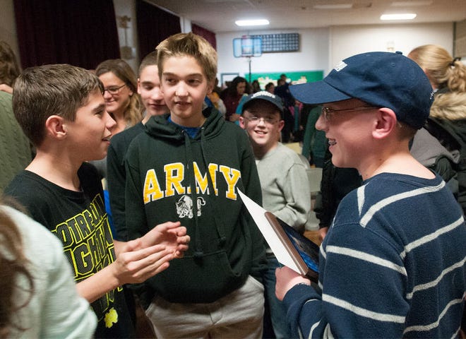 Jeopardy Kid's Week contestant and winner Ryan Elkins, 13, of Bensalem, smiles during a viewing party at his school, St. Charles Borromeo, with friends and family on Tuesday night after it was revealed that he had won the show, taking home over $17,000. Elkins said he is going to put the money toward a college education, possibly at Drexel University.