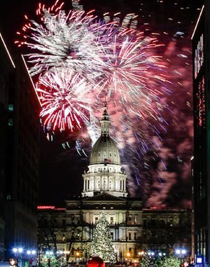 Fireworks erupt over the State Capitol in Lansing, Mich., Friday, Nov. 21, 2014, during the 30th Annual Silver Bells in the City Celebration after the lighting of the official State Capitol Christmas Tree. There's no doubt Michigan could improve its legislative lobbying disclosure laws.