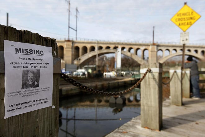 A poster for missing student Shane Montgomery is posted along the Manayunk canal, Sunday, Nov. 30, 2014, in Philadelphia. Police are still looking for clues in the disappearance of the college senior who had been reported missing after a night out with friends at a crowded Philadelphia bar. Police said 21-year-old Montgomery was home from West Chester University and met up with friends Wednesday night at a crowded bar in the Manayunk neighborhood. (AP Photo/The Philadelphia Inquirer, Michael S. Wirtz ) PHIX OUT; TV OUT; MAGS OUT; NEWARK OUT; ONLINES OUT