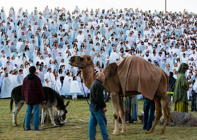 In this photo taken on Monday, Dec. 1, 2014, more than 1,000 participants gather at Rock Canyon Park in Provo, Utah, in an attempt to set a world record for the largest recreation of a live Nativity scene. (AP Photo/The Deseret News, Scott G Winterton) SALT LAKE TRIBUNE OUT; MAGS OUT