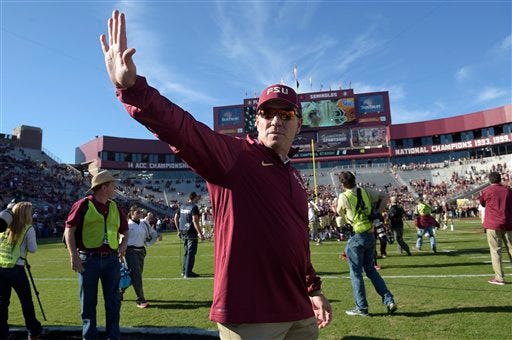 Florida State head coach Jimbo Fisher waves on the field during warmups before an NCAA college football game against Florida in Tallahassee on Saturday. His Seminoles dropped a spot to No. 4 in the latest college football playoff rankings.