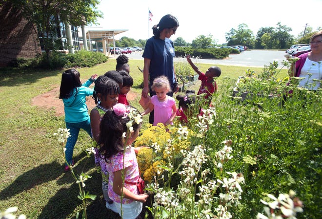 FILE PHOTO - Rashmi Grace, education director for the Druid City Garden Project, teaches pre-k students in Rhonda Nichols's class about gardening at University Place Elementary School Wednesday, May 15, 2013. (Michelle Lepianka Carter / Tuscaloosa News)