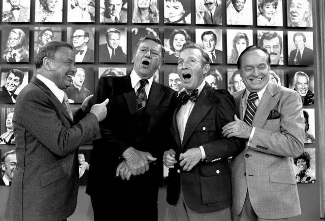 Frank Sinatra, left, and Bob Hope, right, break up over the sight and sound of John Wayne, second from left, and Bing Crosby pretending to sing a duet as the four stars prepare to tape a Bob Hope special in 1975.