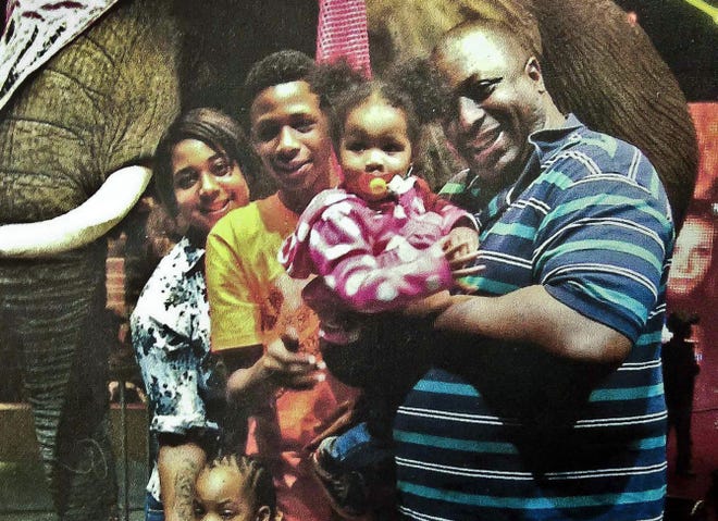 In this undated family file photo provided by the National Action Network, Eric Garner poses with his children during a family outing.