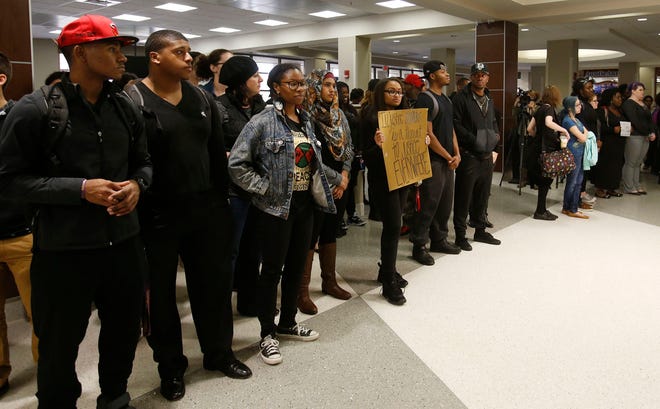 Students at the University of Alabama hold signs during a silent protest held at the University of Alabama Ferguson Center in Tuscaloosa, Ala. on Wednesday Dec. 3, 2014.
