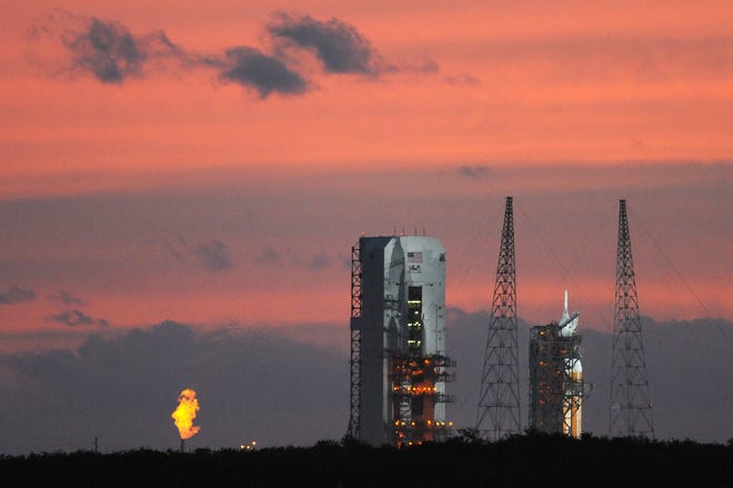Orion sits on the launch pad as dawn breaks Thursday at Space Launch Complex 37 at Cape Canaveral Air Force Station at Kennedy Space Center. The flight was later scrubbed.