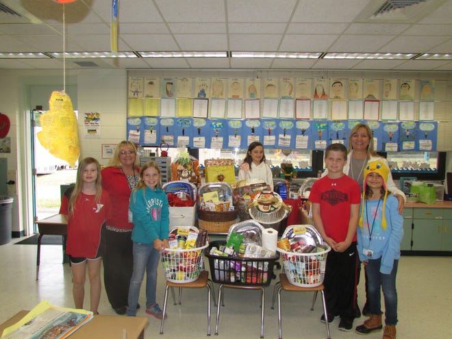 Indian River Elementary FFEA members prepare Thanksgiving baskets that were delivered to needy families are Aramae Satkunas, teacher Angela Donley, Jada Erwin, Kailey Price, Cooper Wilkinson, teacher Theresa Cameron and Rebekah Overley.