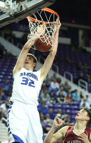 St. John’s Dean Wade dunks past Plainville’s Hadley Gillum in the fourth quarter of the Class 2A state tournament championship game Saturday, Mar. 15, 2014 at Bramlage Coliseum in Manhattan.