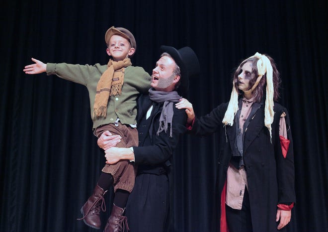 The Dartmouth High School Theatre Company prepares its production of "Scrooge and Marley." From left to right are Robert Sioch as Tiny Tim, Patrick Kitchen as Ebenezer Scrooge and Allyson Morrissette as the ghost of Jacob Marley.

MICHAEL SMITH/STANDARD-TIMES SPECIAL