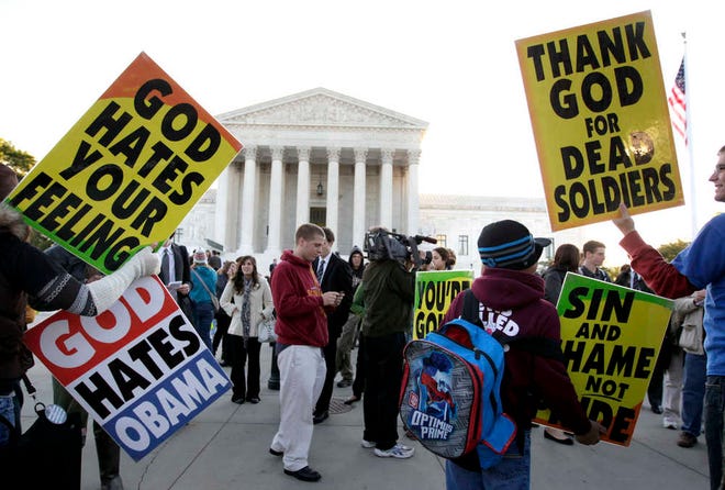 Members of the Westboro Baptist Church picket in front of the Supreme Court in Washington.