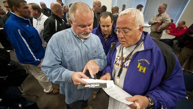 Liberty Hill football coach Jerry Vance, right, and Burnet defensive coordinator Kevin Hall review UIL realignment and reclassification results this past February. After the University Interscholastic League slotted the longtime rivals into different districts, the Panthers and Bulldogs didn’t square off during the football regular season. On Friday night, though, they will meet in a Class 4A, Division I state quarterfinal. CREDIT: Andy Sharp/For American-Statesman