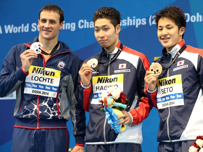From left, Ryan Lochte of the USA, Kosuku Hagino of Japan and Daiya Seto of Japan celebrate on the podium after the men's 200-meter individual medley final at the 12th FINA World Swimming Championships at the Hamad Aquatic on Friday.