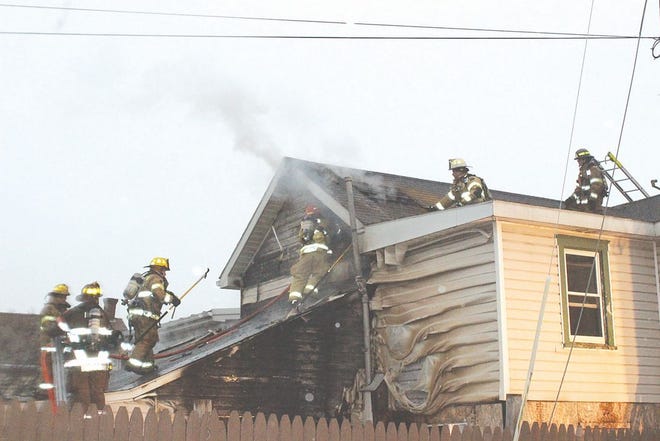Firefighters worked to find the origin of the smoke coming from the roof of the home.