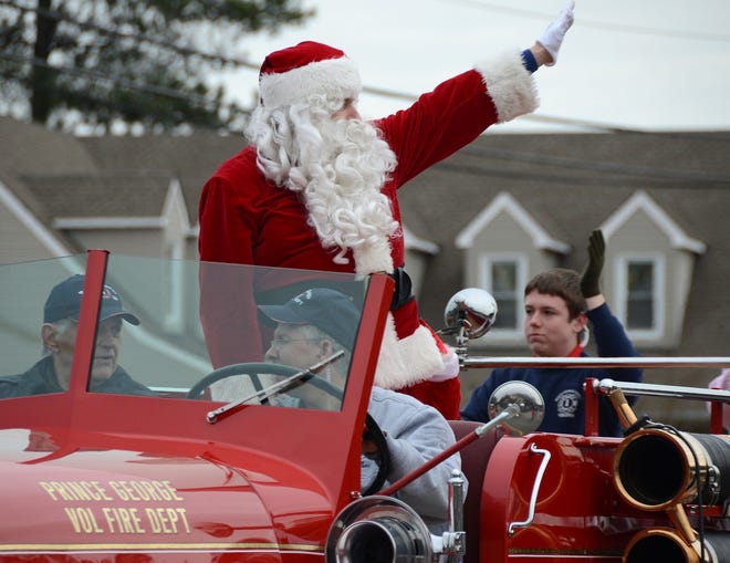 Santa waves from an antique fire truck during the 2013 Prince George County Christmas Parade.