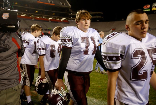 Hubbertville's Mark Adamski (71) walks off the field after the Maplesville Red Devils beat the Lions by a score of 49-0 during the AHSAA Region 7 Class 1A championship game held at Jordan Hare Stadium at Auburn University in Auburn, Ala. on Thursday Dec. 4, 2014. staff photo | Erin Nelson