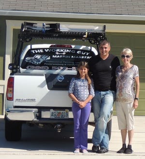 Martina and Martin Marrero pose with Lee Willman in front of Marrero’s Palm Coast home.