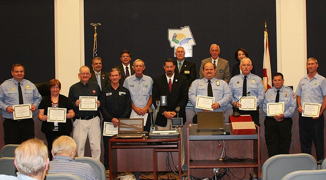County employees honored this week for their years of service include, front row from left, Wayne Semenick, Lori Eichinger, Bob Pickering, James Stevens, David Moltere, County Administrator Craig Coffey, Floyd Herrick, David Preat, Roy Longo, and Timothy Allen. Back row from left are County Commissioners George Hanns, Nate McLaughlin, Frank Meeker, Charlie Ericksen and Barbara Revels.