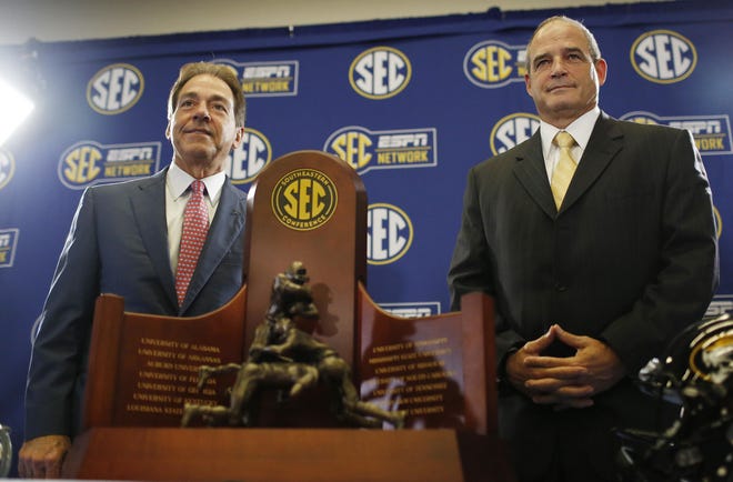 Alabama head coach Nick Saban, left, and Missouri head coach Gary Pinkel pose for photos Friday, Dec. 5, 2014, in Atlanta, ahead of the Southeastern Conference championship football game between Alabama and Missouri held Saturday. (AP Photo/Brynn Anderson)