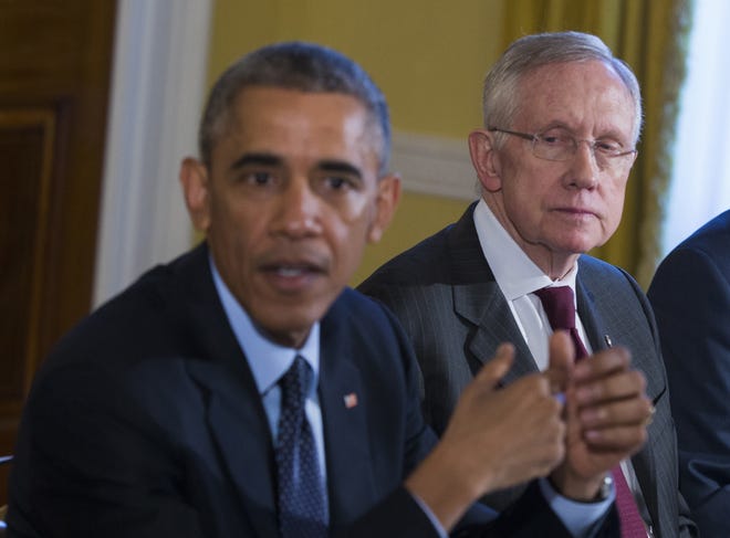 In this Nov. 7, 2014 file photo, Senate Majority Leader Harry Reid of Nev., right, listens as President Barack Obama speaks during a meeting with Congressional leaders in the Old Family Dining Room of the White House in Washington.  In speeches, negotiations, and congressional hearings, several key Democrats are disregarding the White House in ways large and small. The White House has responded with an extraordinary veto threat and a round of Obama calls to Democrats urging them to stand up against their own leadership.