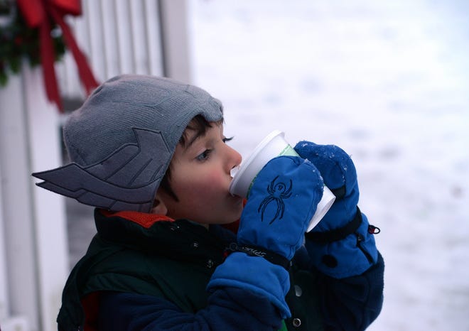 Finn McMeniman, 5, enjoys hot chocolate prior to the tree lighting in North Chelmsford.

Wicked Local Staff Photo/John Walker