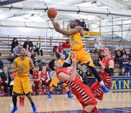 Siena Heights senior guard Christian Covile (0) drives to the basket during Saturday's WHAC game against Concordia.